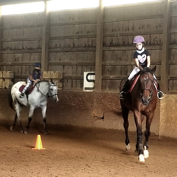 Campers practice their riding skills in our indoor arena.